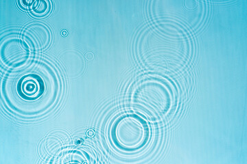 Texture of blue transparent water with splashes. Aqua texture with drops and ripples. Cosmetic micellar spray