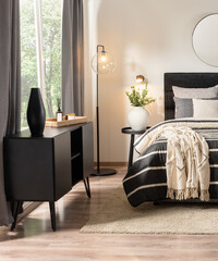 Close-up of Bedroom with Charcoal Striped Upholstered Bed, Adorned with a Cozy Bedspread,...