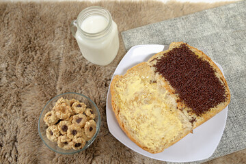 Bread with chocolate choco rice and butter with milk and snack for breakfast