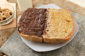 Fototapeta na wymiar Bread with chocolate spread filling, milk and snack for breakfast