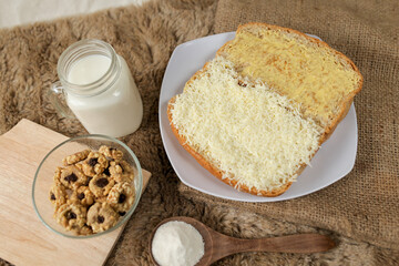 Bread with cheese, sweetened condensed milk, and butter. With white milk and snack on a table for breakfast