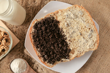 Bread with chocolate cookies oreo cheese and butter spread on a plate for breakfast