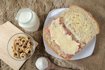 Bread with smoked beef and mozarella cheese on a plate for fast food breakfast or coffee break.
