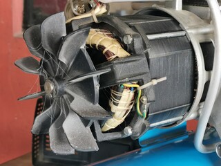 Image of electrical air compressor motor with a fan.