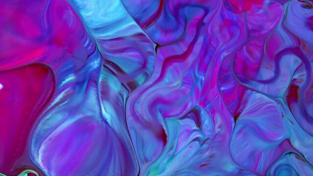 This stock video features an extreme close-up shot of a colorful liquid paint mixture swelling and spreading across the surface to form a unique abstract. 