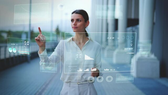 Business woman operates Hologram HUD overlay with various windows and statistics using touch gestures