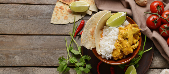 Bowl of tasty chicken tikka masala and rice on table. Banner for design