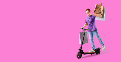 Happy young man with shopping bags riding kick scooter on magenta background with space for text. Black Friday sale