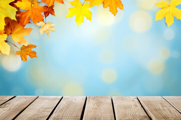 Naklejka na ściany i meble Wooden table against blurred autumn leaves on blue bokeh background. High quality photo