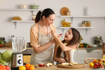 Zelfklevend Fotobehang Little girl with her mother eating fruits while making smoothie in kitchen © Pixel-Shot