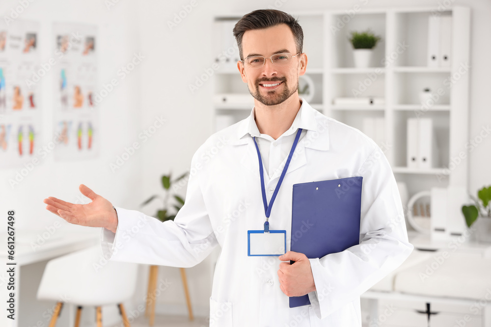 Wall mural Male physiotherapist with clipboard in rehabilitation center