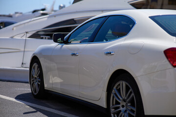 Close up of a white sport car parked in the marina.