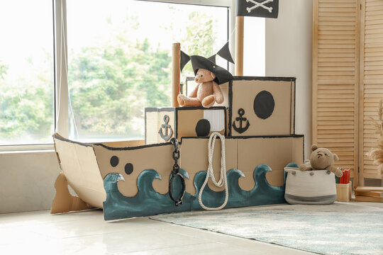 Pirate cardboard ship near window in children's room