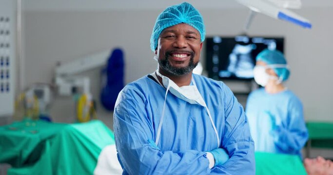 Black man, surgeon and arms crossed, face and confidence with help, support and trust in healthcare. Smile in portrait, cardiology doctor in operation theater for surgery with medical professional