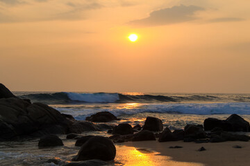 Fototapeta na wymiar Unawatuna beach in Sri Lanka. Waves crashing on the rocks