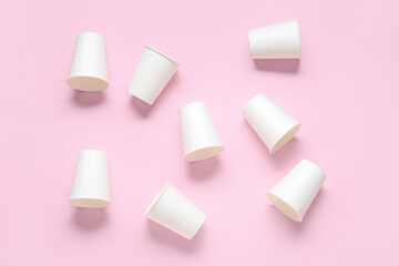 White takeaway paper cups on pink background