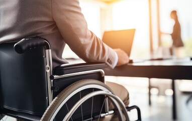 Obraz premium A man working in wheelchair in a modern office