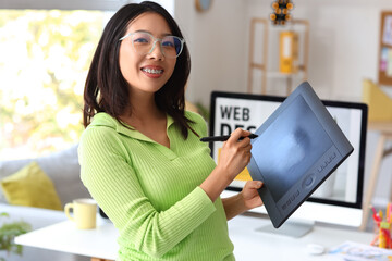 Asian interior designer working with graphic tablet in office