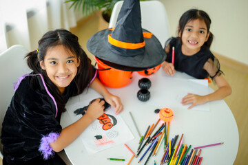 Halloween, holiday and childhood concept. Little kids southeast asian on halloween dressed in a witch costume.