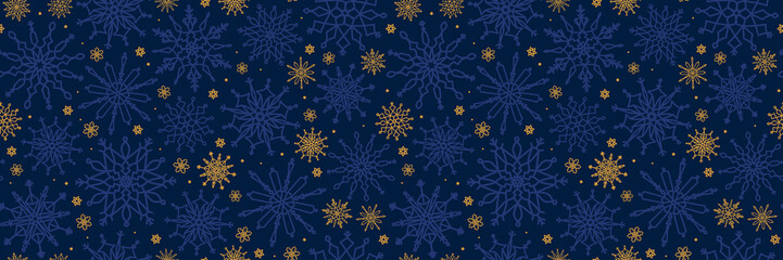 Seamless pattern with blue and yellow snowflakes on a dark blue background