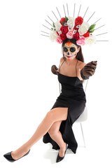 Young woman with painted skull on white background. Mexico's Day of the Dead (El Dia de Muertos) celebration
