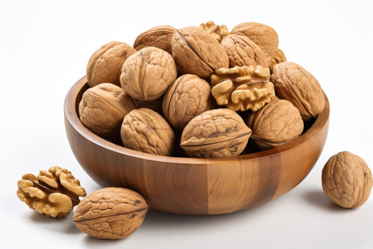 Wooden bowl filled with walnuts sits on top of white surface. This versatile image can be used to represent healthy eating, cooking, autumn, or natural ingredients.