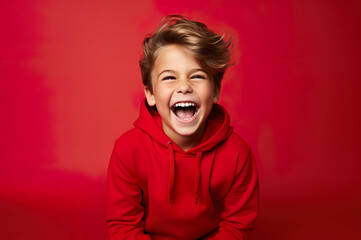 Photo of caucasian happy boy in red clothes over red background - Powered by Adobe