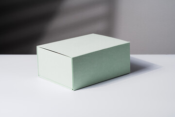 Square gift box, luxury shopping, mock up. White and gray background. Studio shot