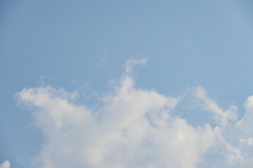 beautiful blue sky and white fluffy cloud with sunrise in the morning, natural background