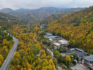 Almaty, Kazakhstan - 10.02.2023 : An asphalt road in a mountainous area with different vegetation.