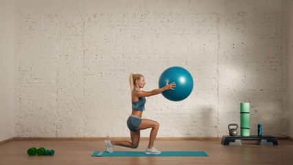 Healthcare creative advertisement concept. Woman fitness coach in the room doing lunges with balance ball.