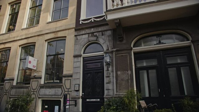Tilt up of beautiful canal-side house in Amsterdam city center on a sunny day