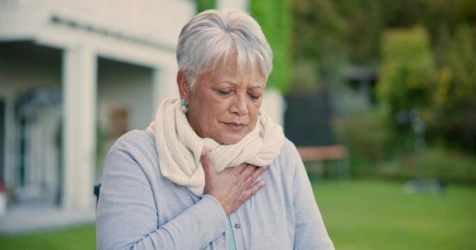 Chest pain, park and senior woman in wheelchair for emergency, injury and heart attack outdoors. Healthcare, retirement and elderly person in nature with heartburn, cardiovascular problem and hurt