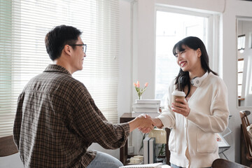 Young students sit in the library studying, sharing knowledge and holding hands. Educational concept