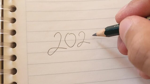 2023 to 2024 year changing concept with handwriting on notebook