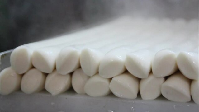 White rice cakes freshly pulled out of the mill machine