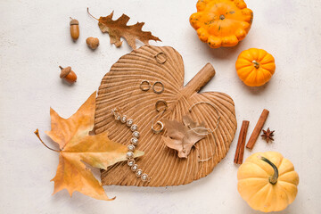 Composition with different female accessories and autumn decor on light background
