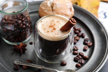Plate with cup of aromatic coffee, beans and muffin, closeup