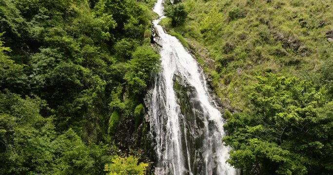 Waterfall in the mountains among the green forest. Efrata falls. Sumatra, Indonesia.