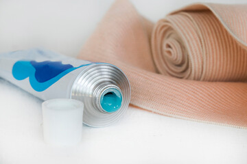 topical medication with roll bandage for first aid accident arrangement flat lay on background white
