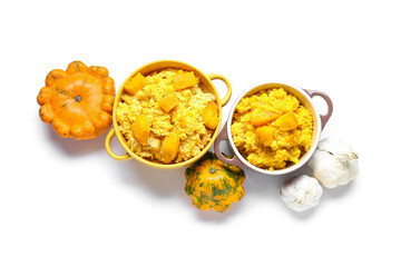Pots of tasty millet porridge with pumpkin on white background