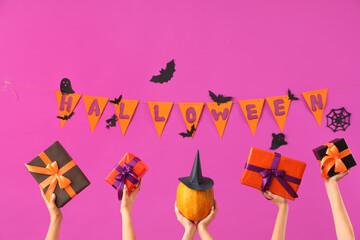 Women with Halloween gifts and decor on purple background