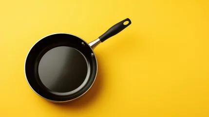 Foto op Plexiglas frying pan on yellow background.  © Nanda