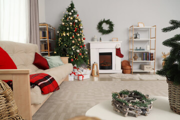 Interior of living room with sofa, fireplace and Christmas tree
