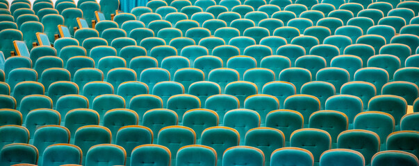Empty soft chairs in the cinema hall.