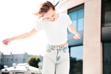 Portrait of beautiful smiling brunette model. Trendy female posing in the street background. Funny...