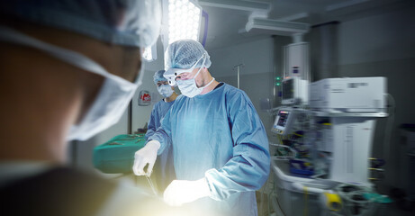 Medical, teamwork and doctors in a hospital for surgery together, working in theater to save a...