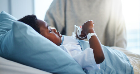 Sick black kid in hospital at bed for healthcare, recovery from virus or healing injury in...