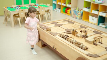 Adorable 3-year-old Girl Toddler Playing With Wooden Cars in Modern Playroom
