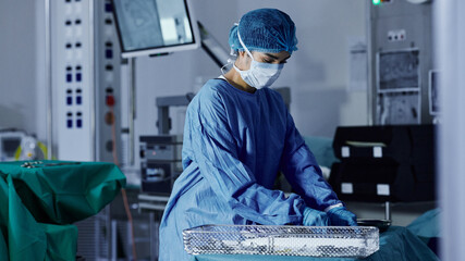 Surgery room, woman and doctor in a hospital, prepare and healthcare with safety, medicare and...